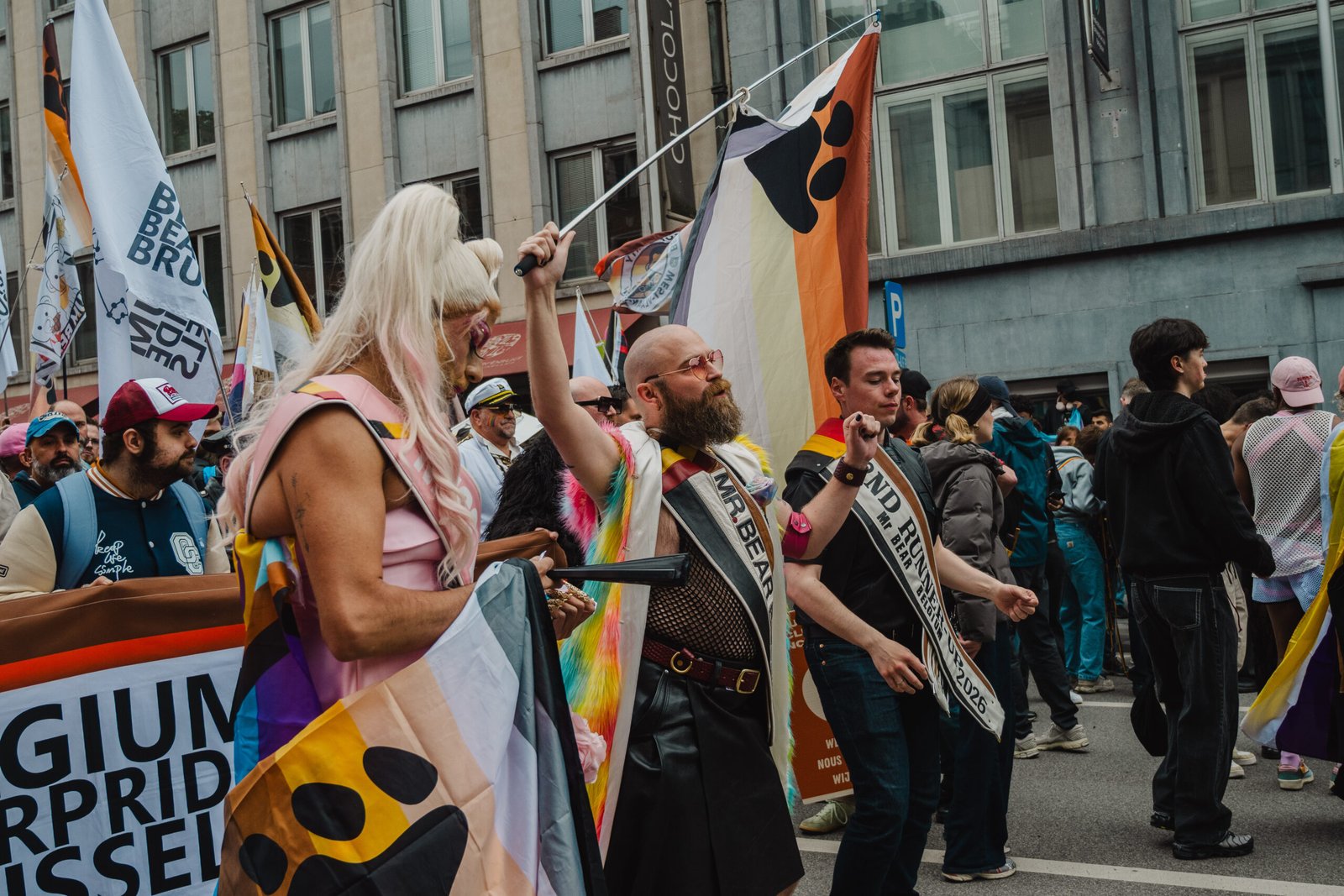 Pride parade with colorful flags and costumes