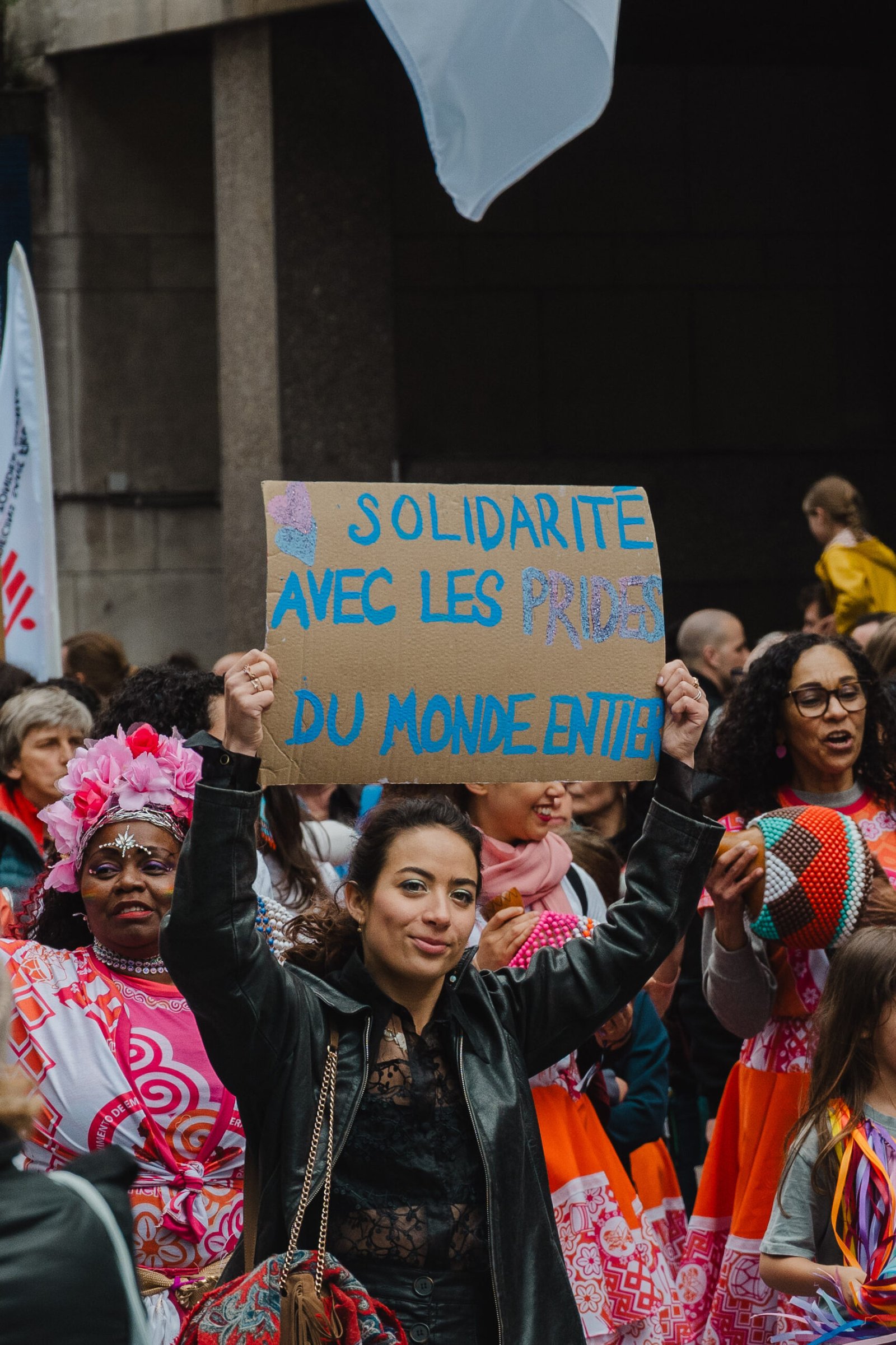 Woman holding solidarity sign at pride parade