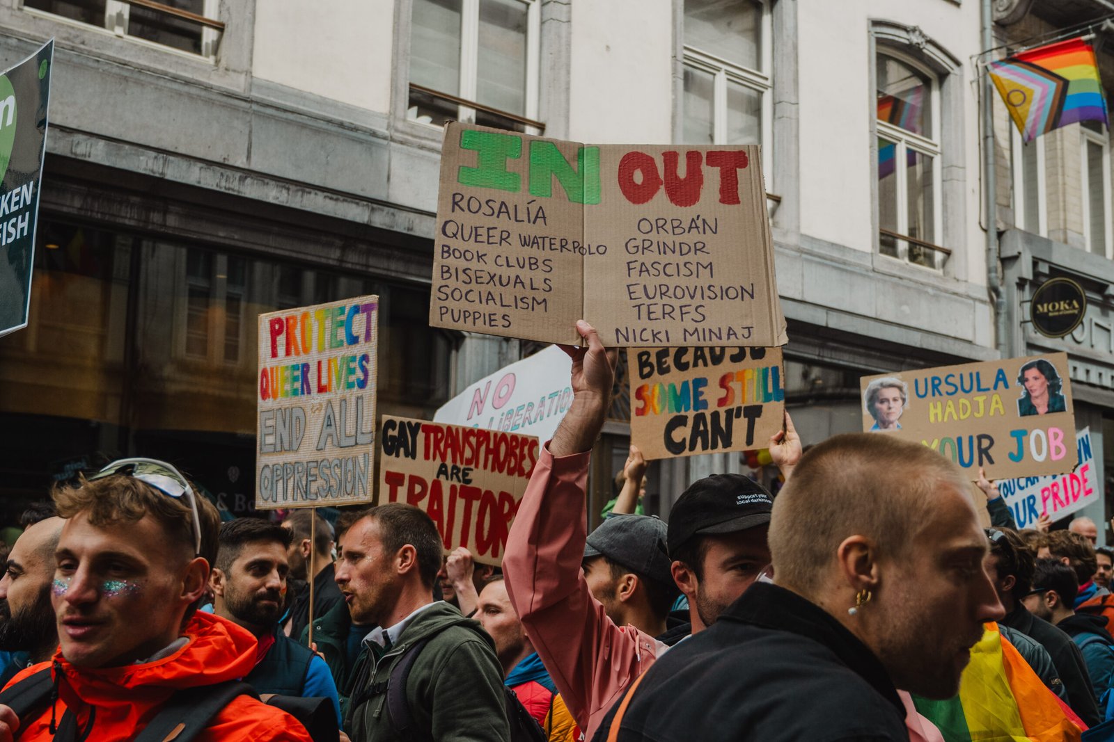 Pride march with diverse protest signs