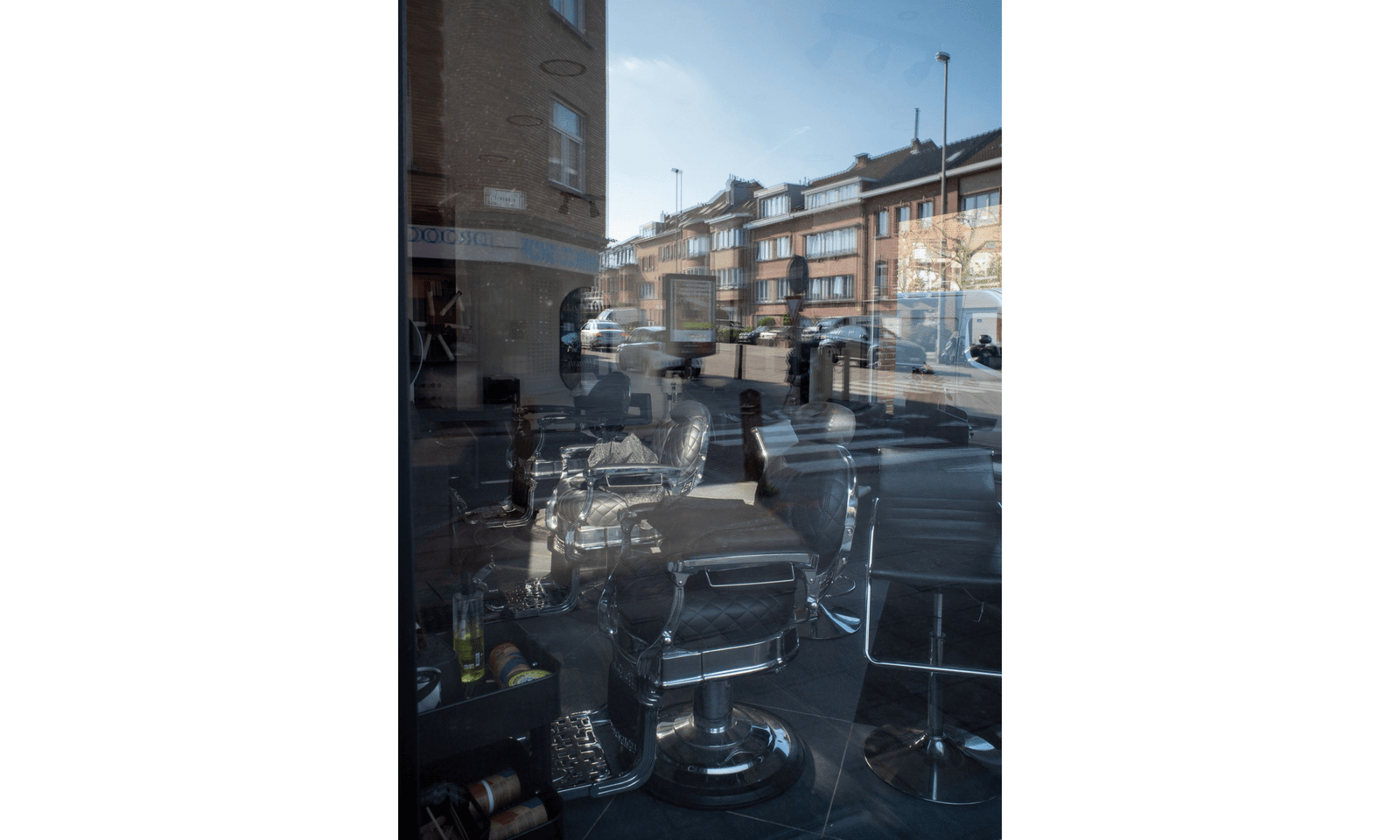 Reflections on a window of a street and a hairsalon inside